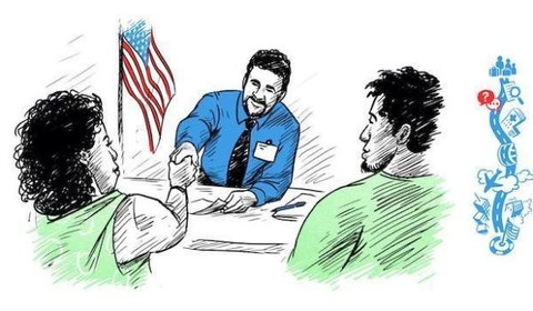 A man in a blue shirt is sitting at a desk, shaking hands with a woman in a green shirt. Another man in a green shirt is sitting beside her. An American flag is visible in the background, suggesting a formal or official setting.