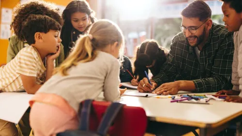 Students engaging in an after-school program with an adult leading the activity