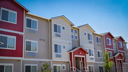 Photo of a row of modern three-story apartments.