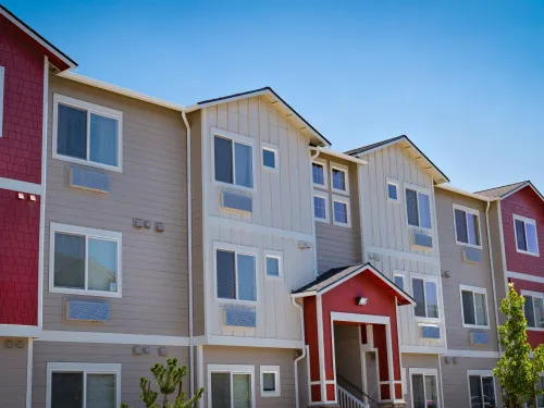 Photo of a row of modern three-story apartments.