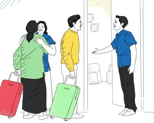 Un hombre y una mujer dan la bienvenida a los recién llegados a su hogar.