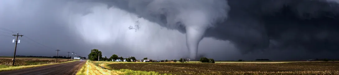 Tornado moving across a country landscape