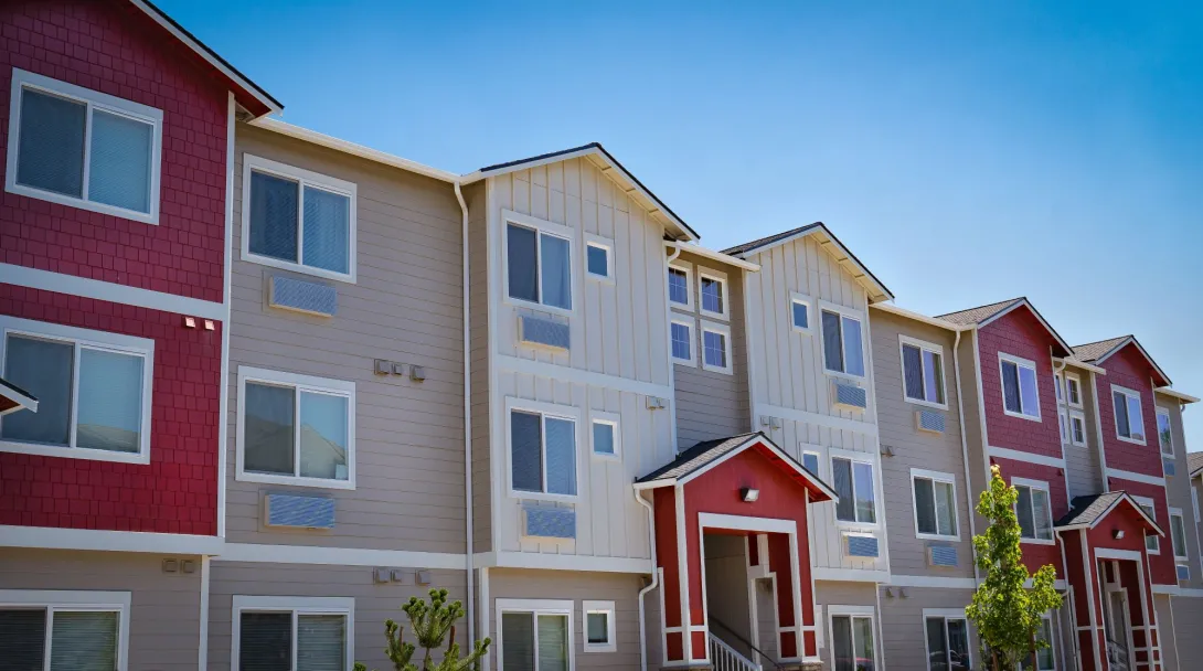 Photo of a row of modern three-story apartments.